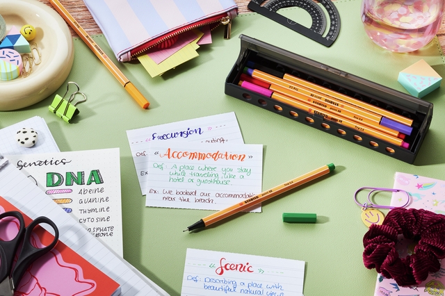 notebook, pencils, scissors, eraser, office desk